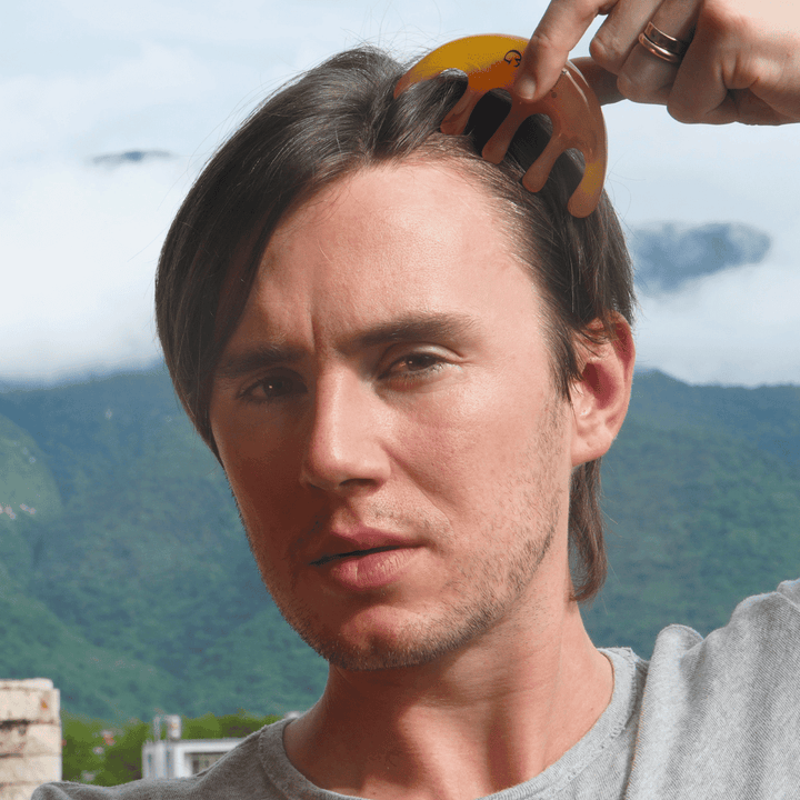 Jude Massey using the comb on his scalp